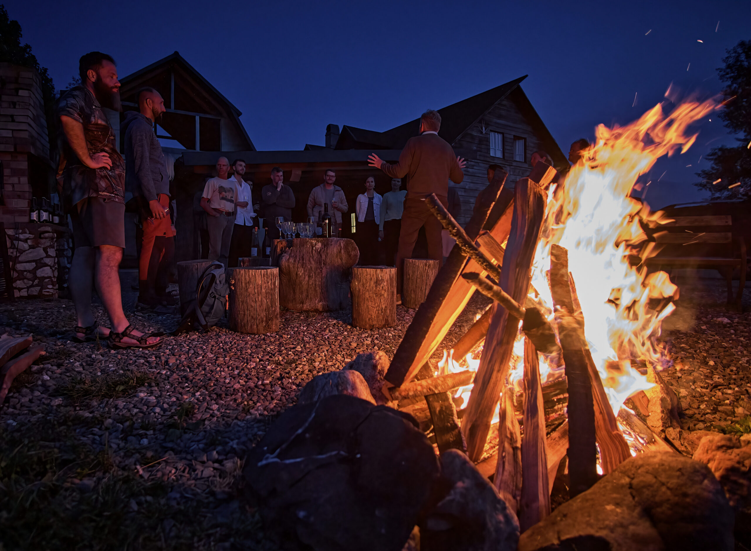 Group of tourists, enjoying a night at the fire place at a cozy accommodation